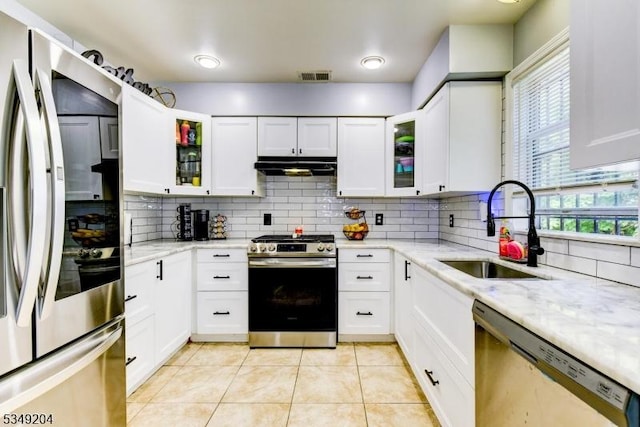 688 S 18th St, Newark City, NJ 07103 - kitchen featuring stainless steel appliances, a sink, under cabinet range hood, light tile patterned floors, and tasteful backsplash