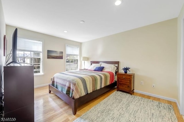 bedroom featuring baseboards, recessed lighting, and wood finished floors
