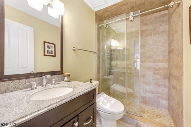 bathroom with vanity, a stall shower, and toilet