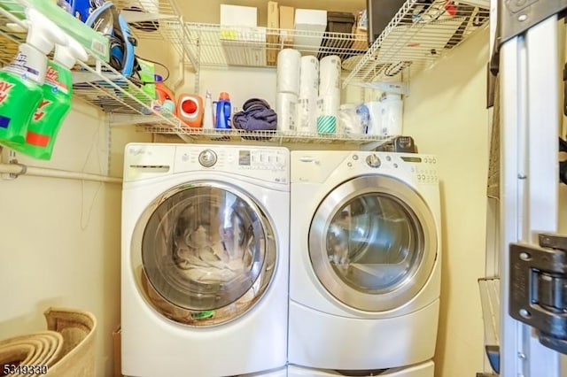clothes washing area with separate washer and dryer and laundry area