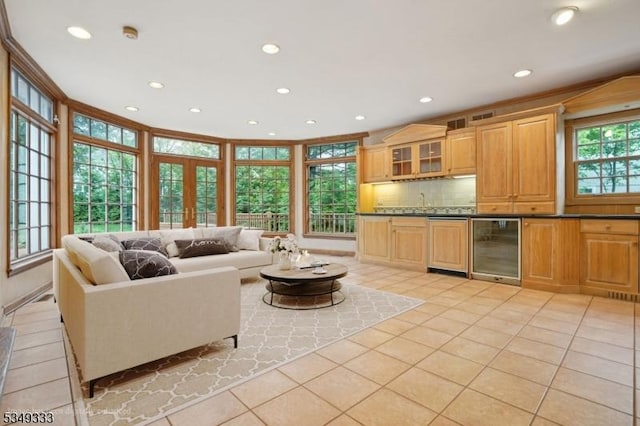 living area featuring beverage cooler, light tile patterned floors, and recessed lighting