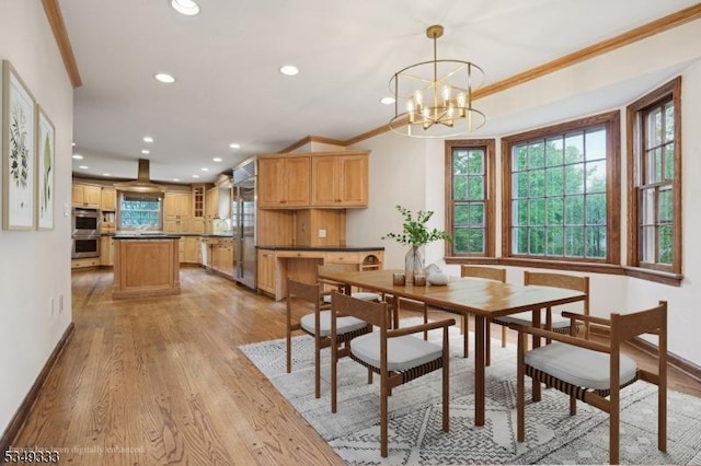 dining room featuring light wood-style floors, a chandelier, recessed lighting, baseboards, and ornamental molding