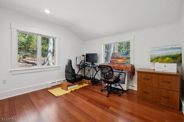home office featuring a healthy amount of sunlight, vaulted ceiling, a baseboard heating unit, and wood finished floors