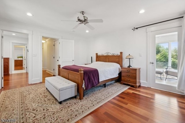 bedroom with access to outside, baseboards, recessed lighting, and wood finished floors
