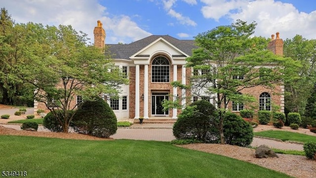 24 Glenview Dr, Warren Twp, NJ 07059 - greek revival inspired property featuring a chimney and a front lawn