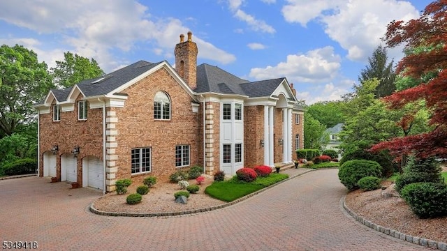 24 Glenview Dr, Warren Twp, NJ 07059 - view of building exterior featuring decorative driveway and an attached garage