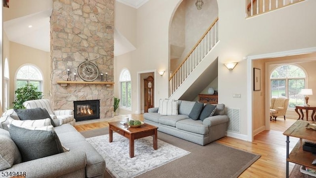 24 Glenview Dr, Warren Twp, NJ 07059 - living room with a towering ceiling, healthy amount of natural light, wood finished floors, a fireplace, and stairway