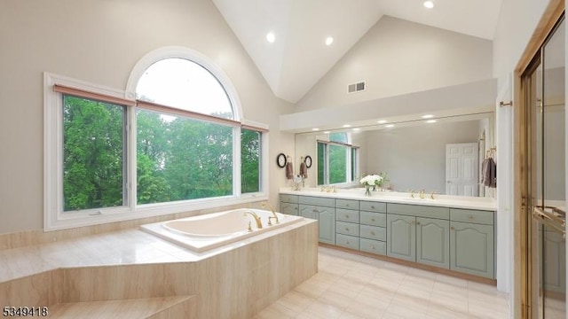 24 Glenview Dr, Warren Twp, NJ 07059 - bathroom featuring double vanity, a garden tub, recessed lighting, high vaulted ceiling, and tile patterned flooring