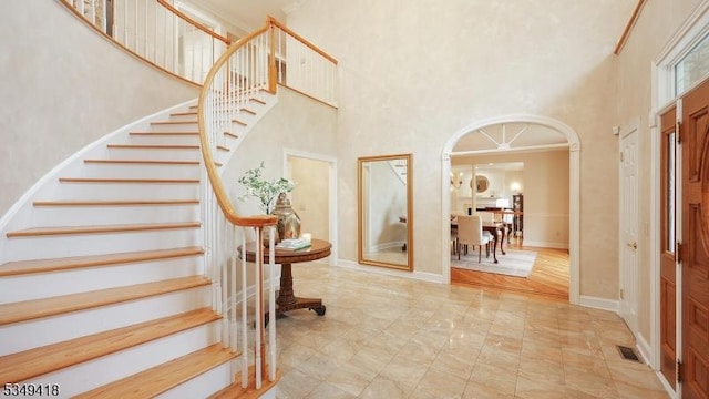 24 Glenview Dr, Warren Twp, NJ 07059 - entryway with a towering ceiling, stairway, arched walkways, and marble finish floors