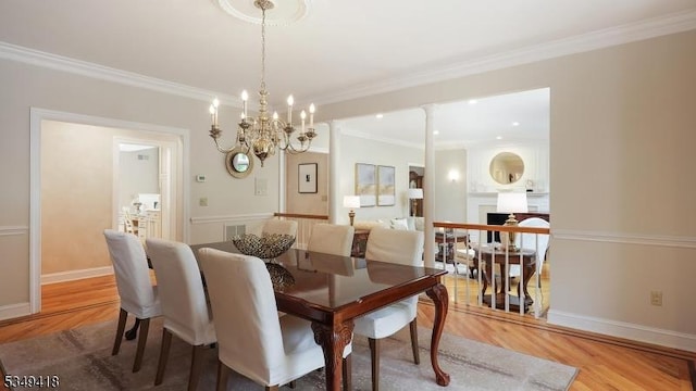 24 Glenview Dr, Warren Twp, NJ 07059 - dining room with light wood finished floors, crown molding, baseboards, and a chandelier
