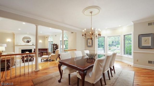 24 Glenview Dr, Warren Twp, NJ 07059 - dining room with a fireplace, recessed lighting, ornamental molding, a chandelier, and light wood-style flooring