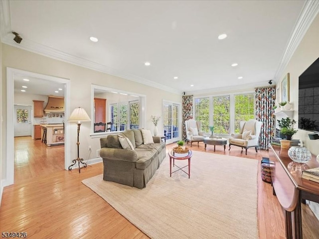 living room featuring crown molding, recessed lighting, and light wood finished floors