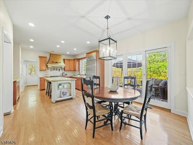 dining room with light wood-type flooring, recessed lighting, and a chandelier