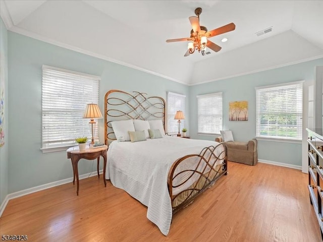 bedroom featuring visible vents, wood finished floors, baseboards, ceiling fan, and vaulted ceiling