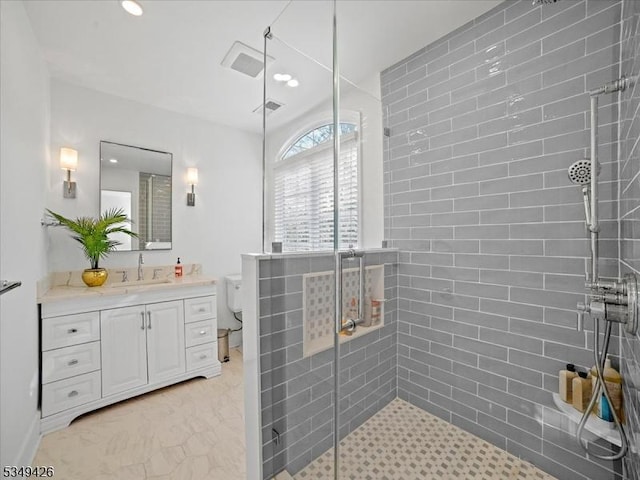 bathroom featuring vanity, visible vents, toilet, recessed lighting, and a stall shower