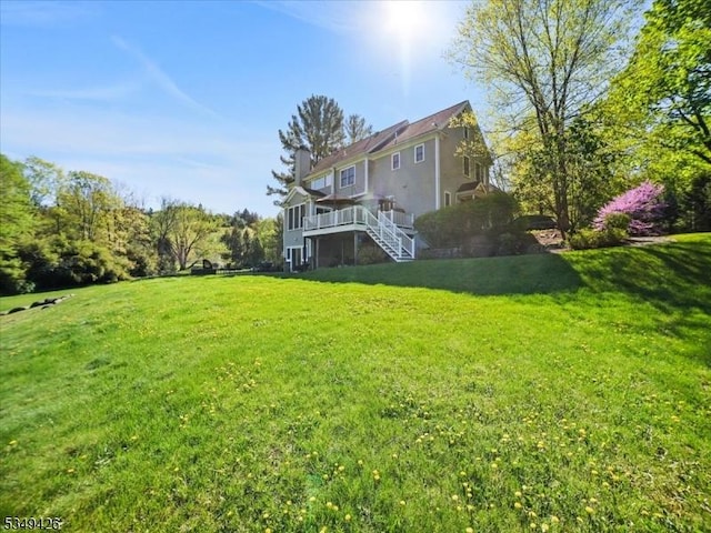 view of yard featuring a wooden deck and stairway