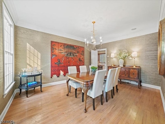 dining room with baseboards, an inviting chandelier, a wealth of natural light, and light wood-style flooring