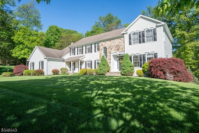 view of front of property with a front lawn and stone siding