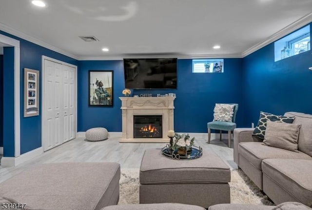 living area with crown molding, wood finished floors, and a wealth of natural light