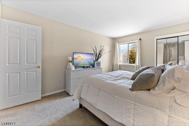 carpeted bedroom with baseboards