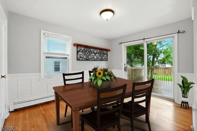 59 James St, Morristown Town, NJ 07960 - dining room featuring a baseboard heating unit, wainscoting, light wood-type flooring, and a decorative wall