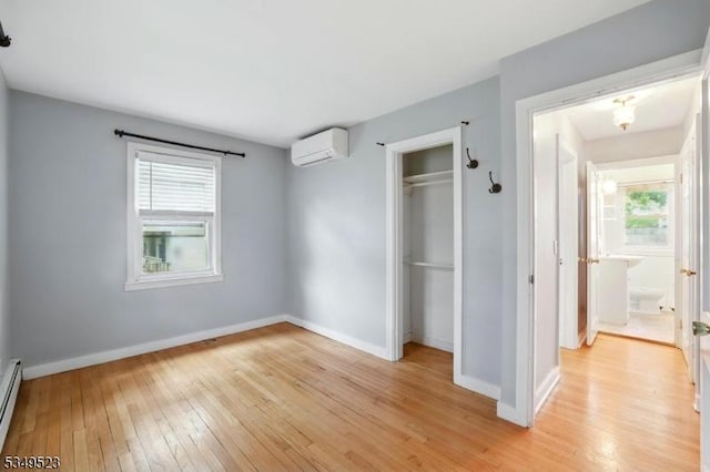 59 James St, Morristown Town, NJ 07960 - unfurnished bedroom featuring a wall mounted AC, light wood finished floors, a closet, and baseboard heating