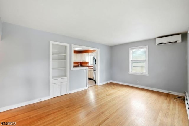 59 James St, Morristown Town, NJ 07960 - unfurnished living room featuring a wall mounted AC, light wood finished floors, and a baseboard heating unit
