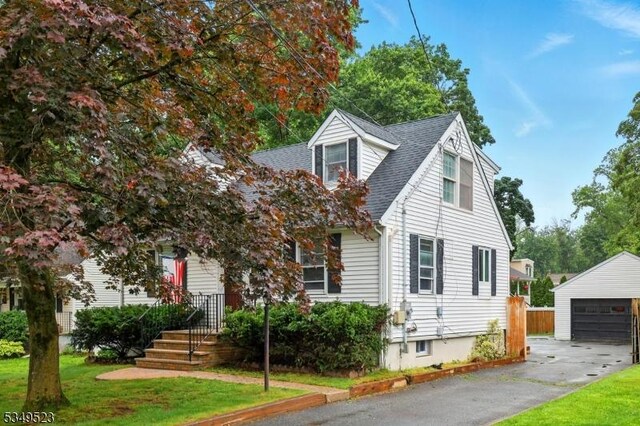 59 James St, Morristown Town, NJ 07960 - cape cod house featuring an outbuilding, a garage, a shingled roof, and a front yard