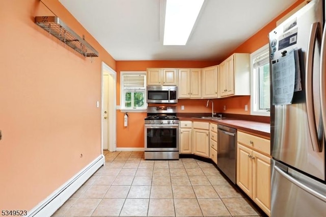 59 James St, Morristown Town, NJ 07960 - kitchen with appliances with stainless steel finishes, baseboard heating, healthy amount of natural light, and light tile patterned floors