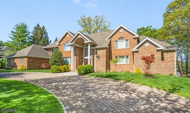 30 Mountain Ridge Dr, Livingston Twp, NJ 07039 - traditional-style house featuring brick siding and a front lawn