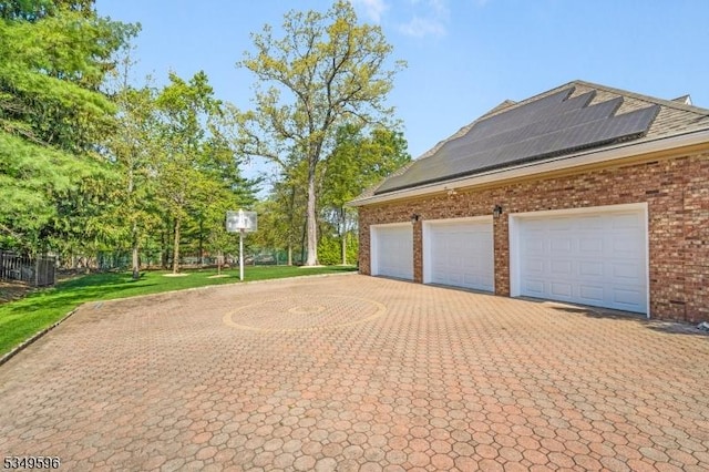 30 Mountain Ridge Dr, Livingston Twp, NJ 07039 - garage with decorative driveway and roof mounted solar panels