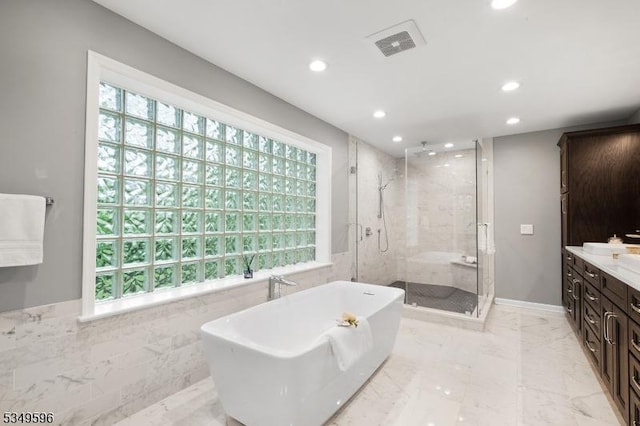 30 Mountain Ridge Dr, Livingston Twp, NJ 07039 - bathroom with recessed lighting, a stall shower, healthy amount of natural light, a soaking tub, and tile walls