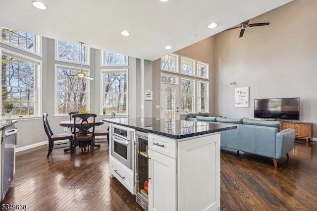 kitchen with dark wood-style flooring, recessed lighting, white cabinetry, and a healthy amount of sunlight