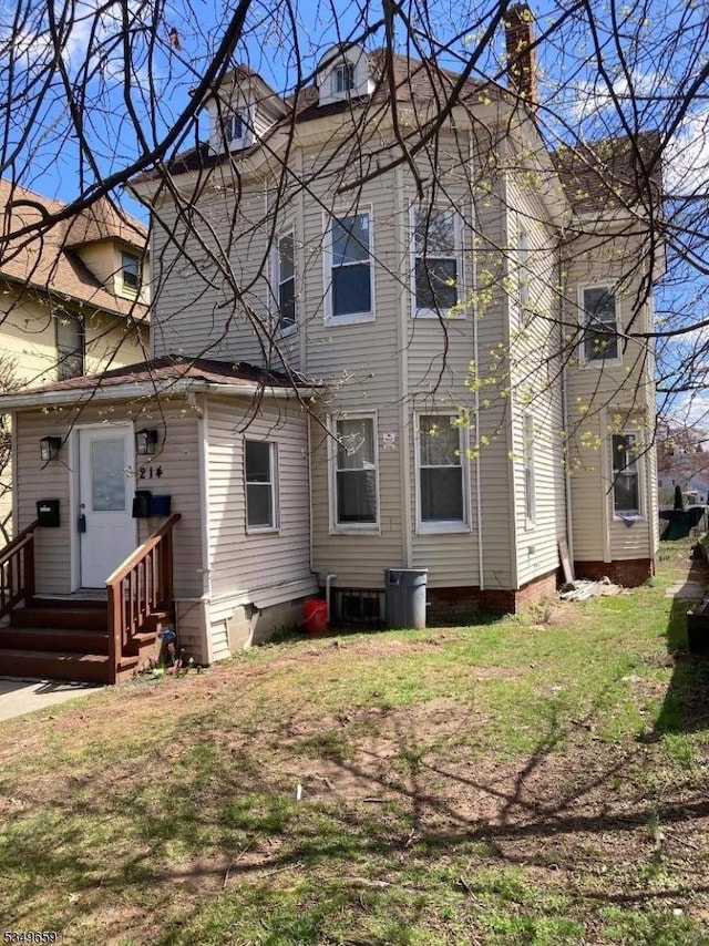 214 Cleveland St, City Of Orange Twp, NJ 07050 - rear view of property with entry steps, a lawn, and crawl space