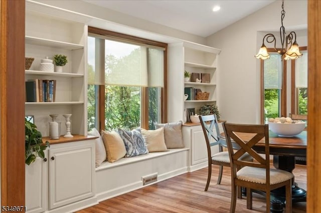 living area featuring a chandelier, light wood-style flooring, and recessed lighting