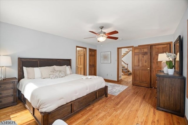 bedroom with light wood finished floors, baseboards, and a ceiling fan