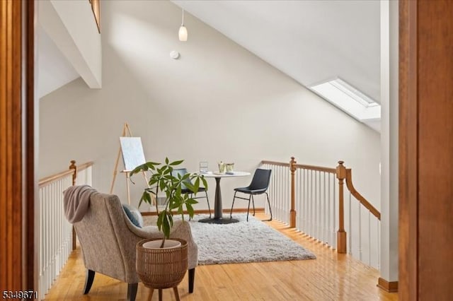 sitting room with a skylight and wood finished floors