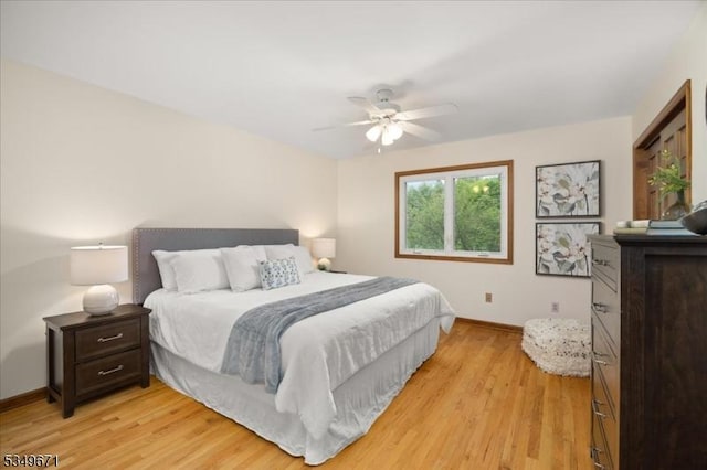 bedroom featuring baseboards, light wood-style flooring, and ceiling fan