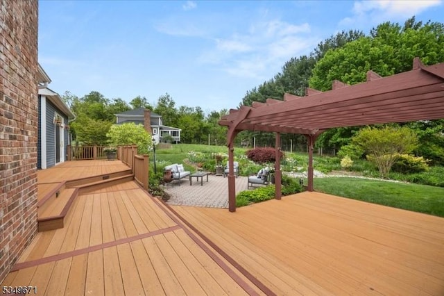 wooden terrace featuring a pergola, a lawn, and a patio area