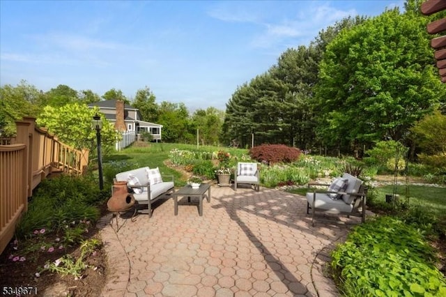 view of patio / terrace featuring an outdoor hangout area and fence