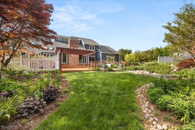 rear view of property with a wooden deck and a pergola