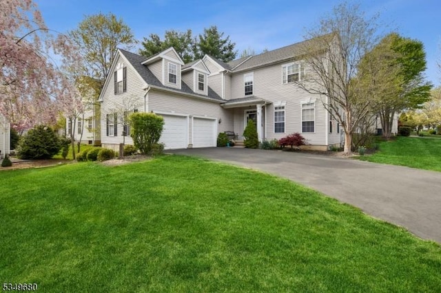 traditional home with driveway, a front lawn, and a garage