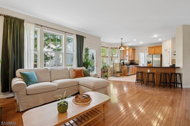 living area featuring recessed lighting and light wood-type flooring