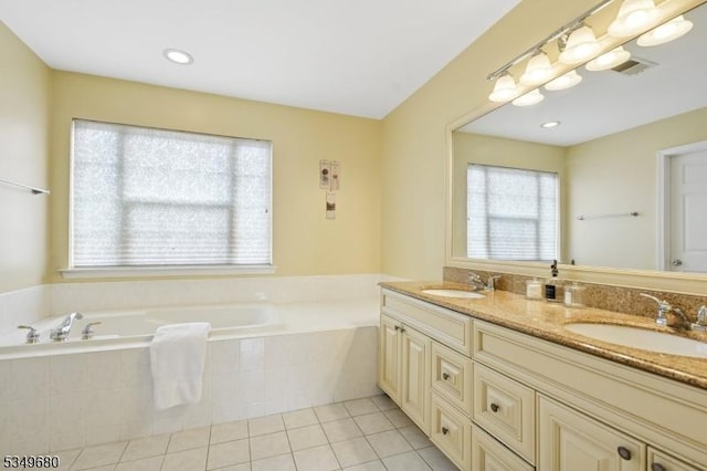 bathroom with a sink, tile patterned floors, a garden tub, and double vanity