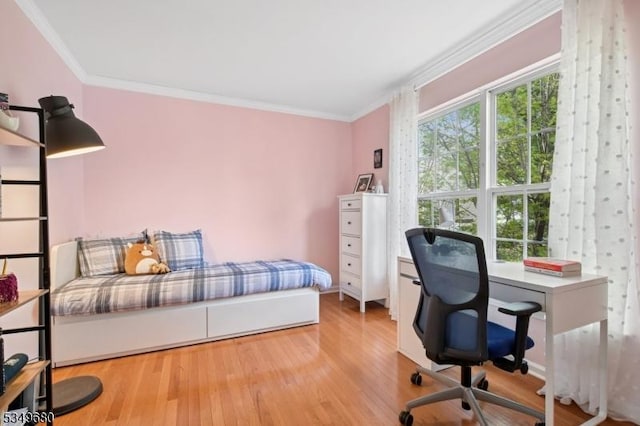 bedroom featuring crown molding and wood finished floors