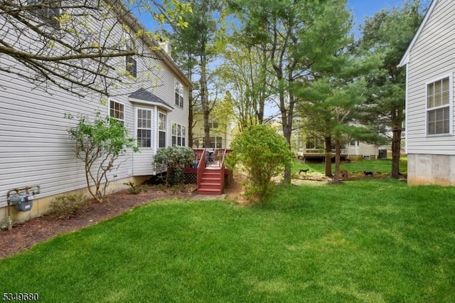 view of yard with a wooden deck