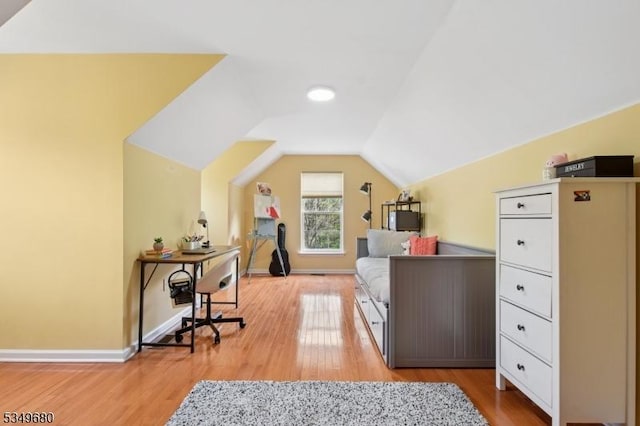 bedroom with baseboards, light wood-style flooring, and lofted ceiling