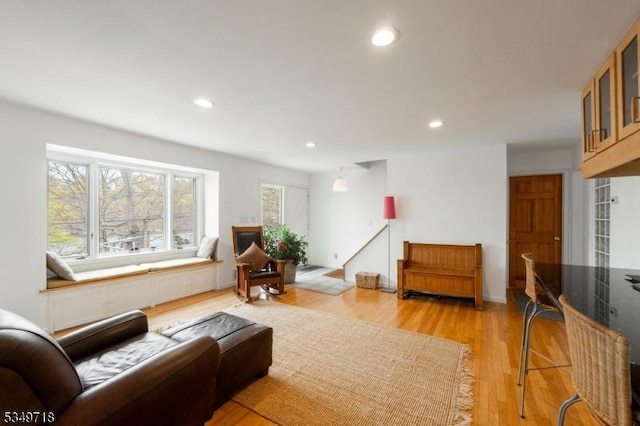 living room with light wood-style flooring and recessed lighting