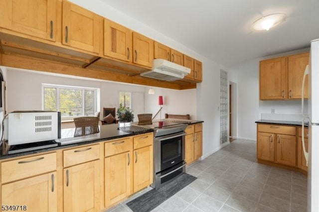 kitchen with dark countertops, light tile patterned floors, electric range, under cabinet range hood, and freestanding refrigerator