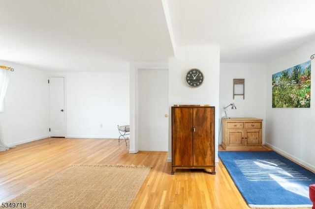 interior space with light wood finished floors and baseboards